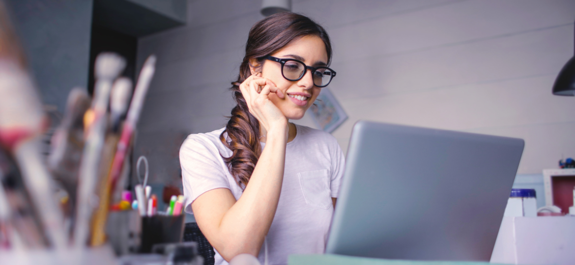 What Is Contract Work Blog Graphic that showcases a woman on the phone in front of her laptop.